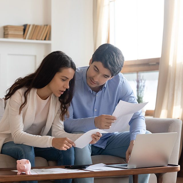 Young couple concerned about property pricing